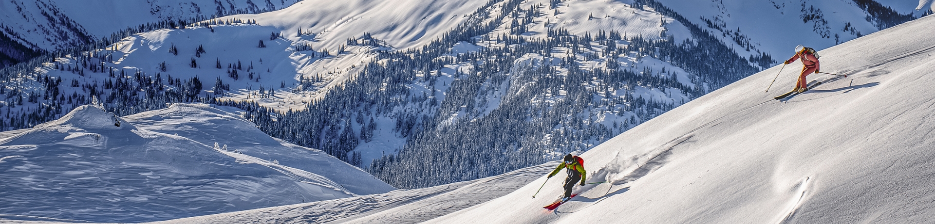A skier skis down Whistler Blackcomb during sunset