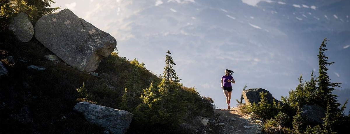 A woman running on a trail