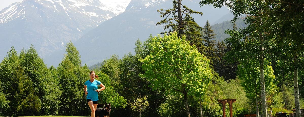 A woman and her dog running
