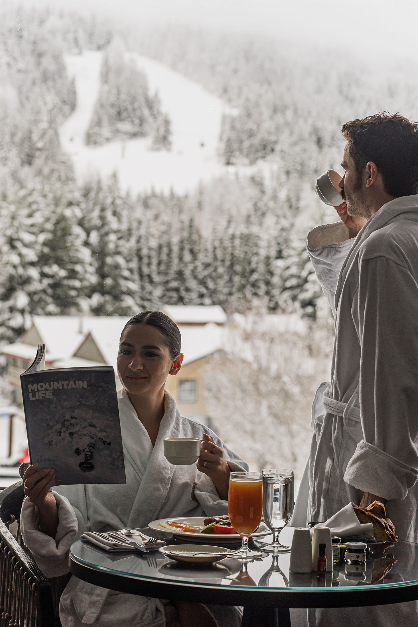 fairmont chateau whistler breakfast romantic couple looking towards blackcomb mountain winter