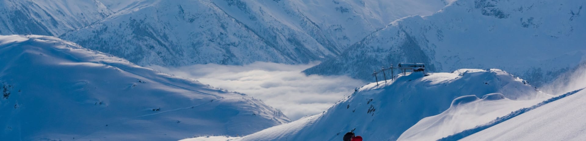 Skier skiing powder at sunset
