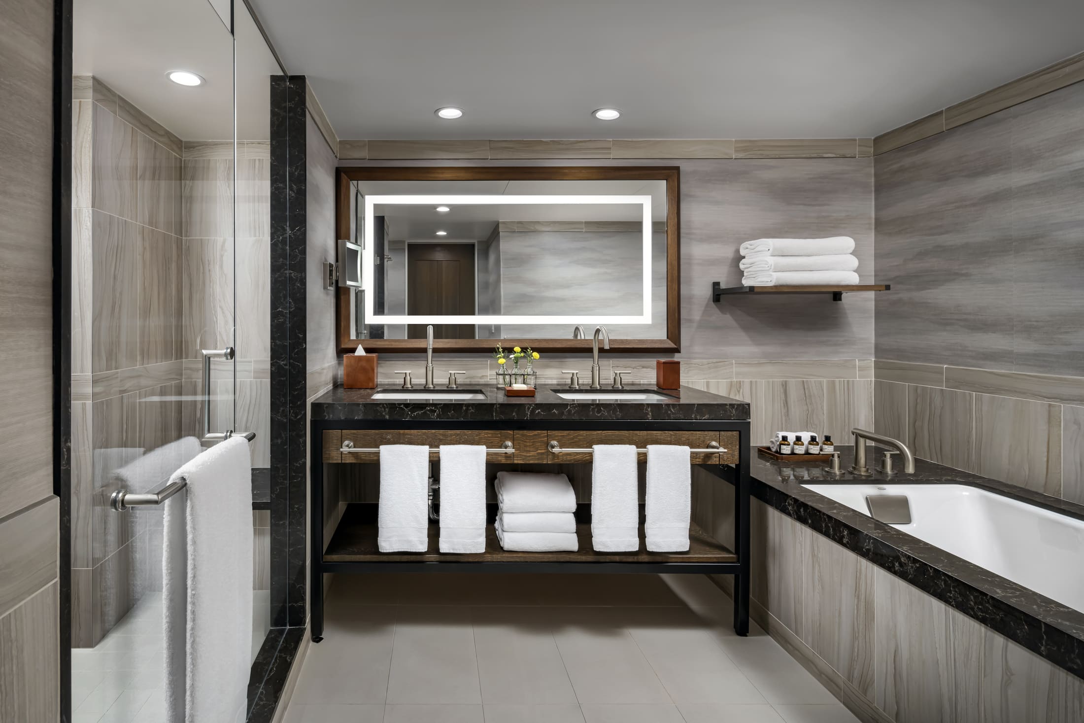 large bathroom with walk-in shower, bathtub and twin sinks