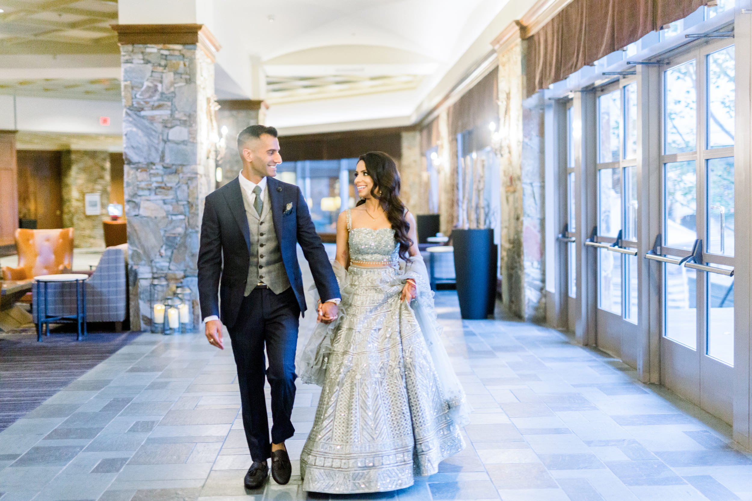 bride and groom walking down the hallway