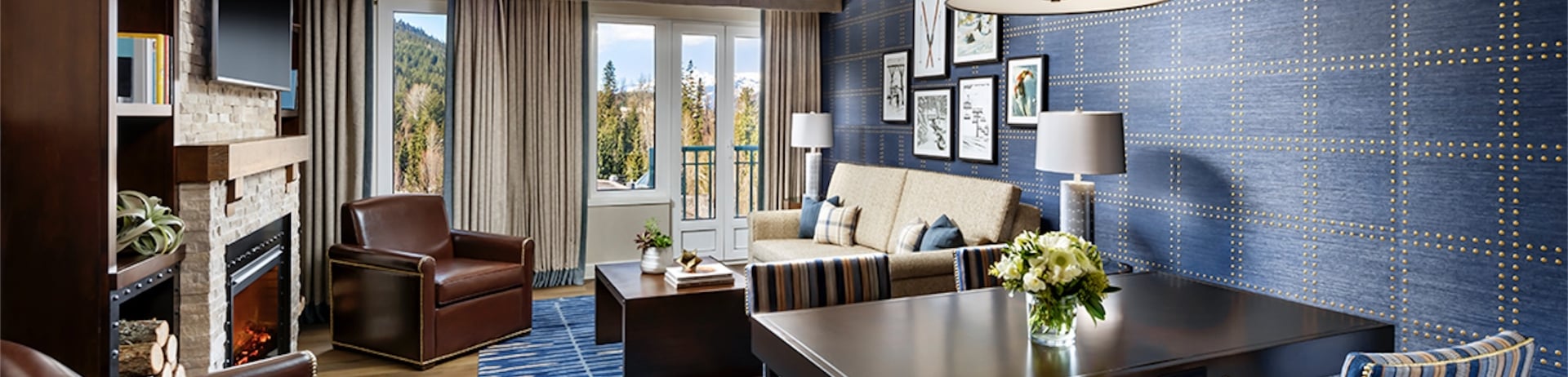 interior of one bedroom hotel room living room area with views of mountain area through window