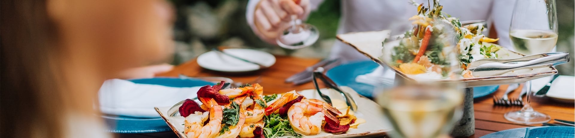 couple drinking wine with shrimp appetizers