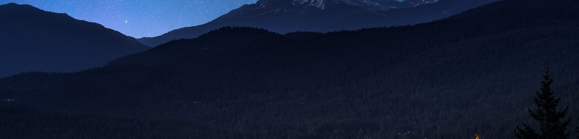 Landscape view of Chateau Whistler lit up at night