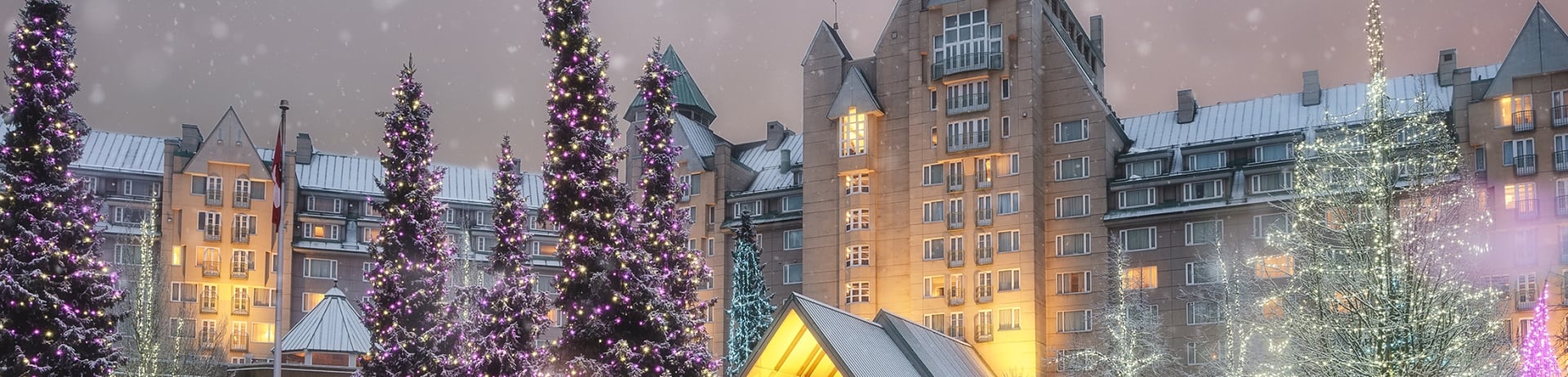 Front of Fairmont Chateau Whistler decorated for the holidays at night
