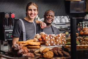 portobello employees standing behind a display of baked goods