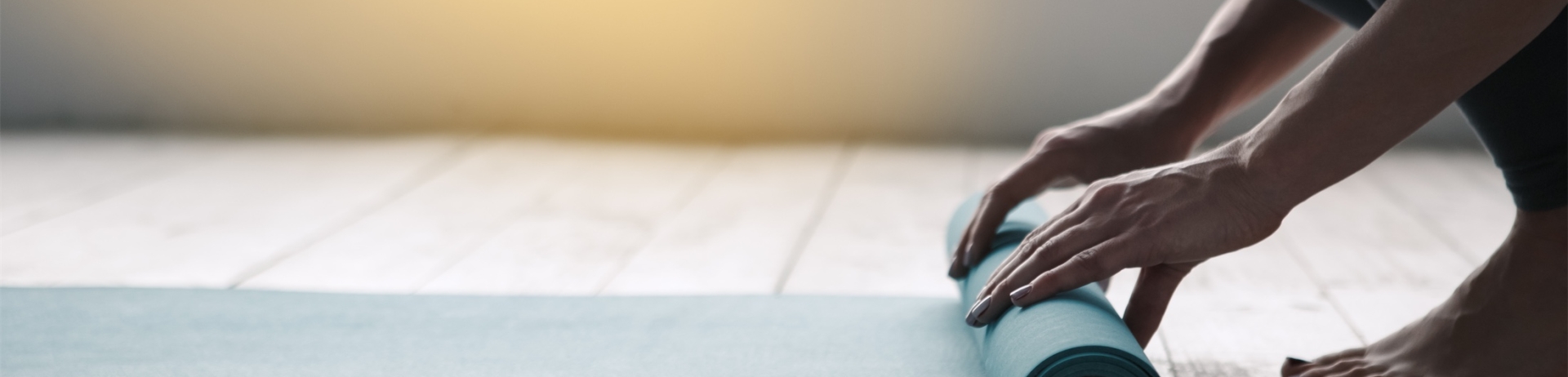 Young woman doing yoga twisting mat indoors near window