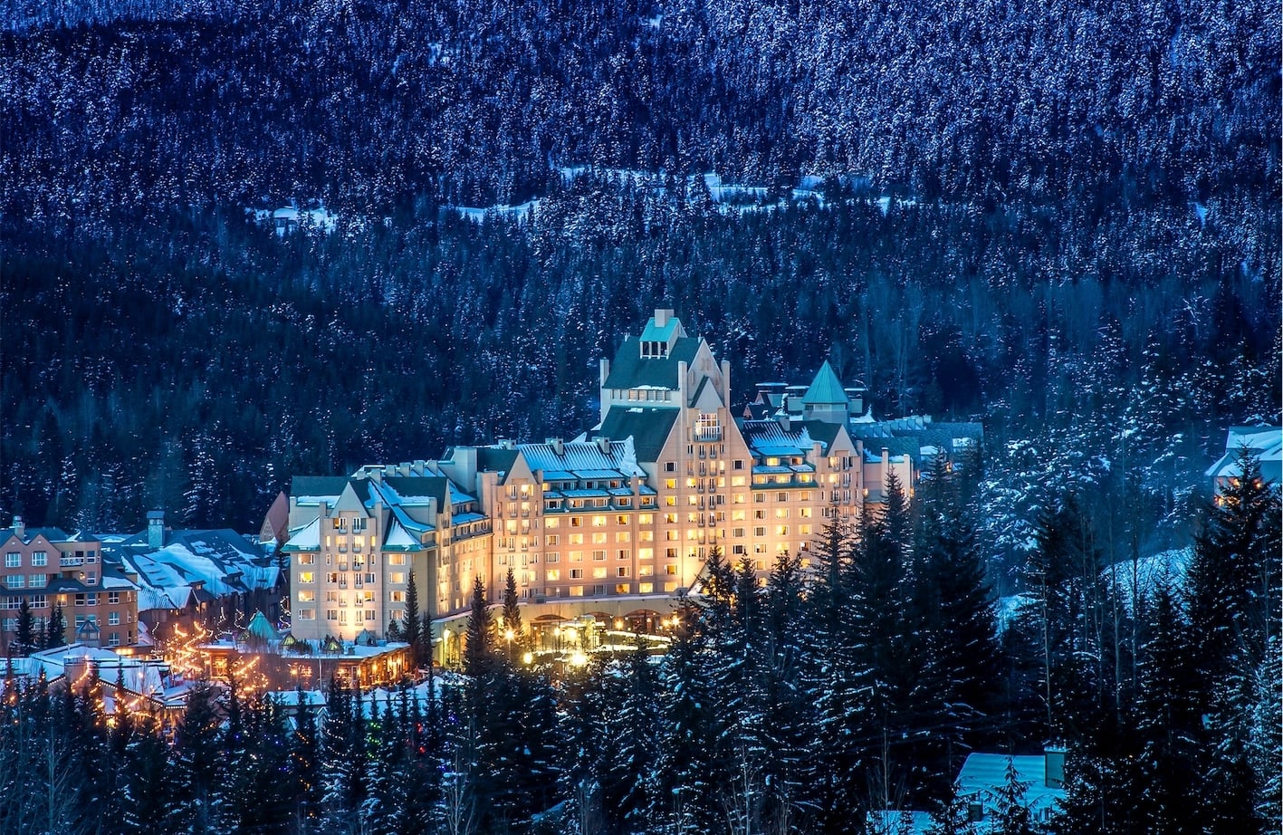 zoomed out shot of chateau whistler next to a large mountain