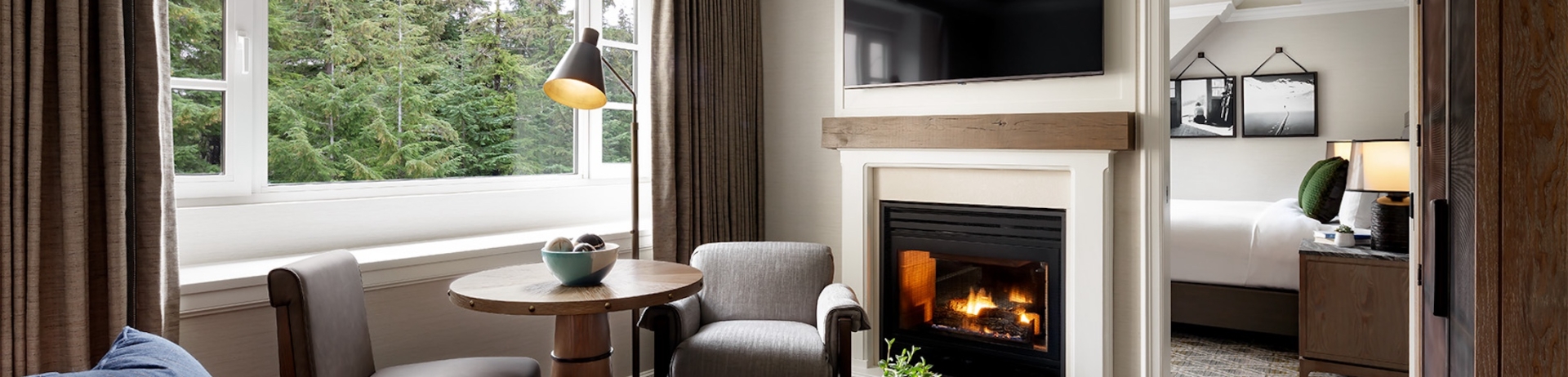 living room with sofa and fireplace with view of the bedroom
