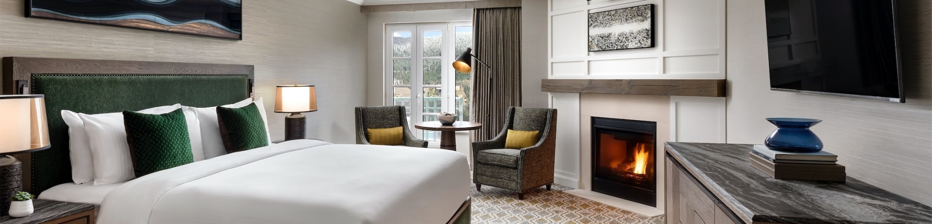 bedroom with two chairs and a small table next to a fireplace