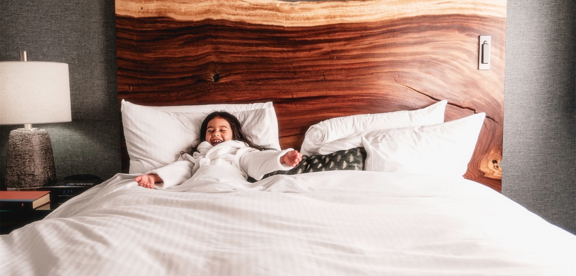 little girl tucked into bed