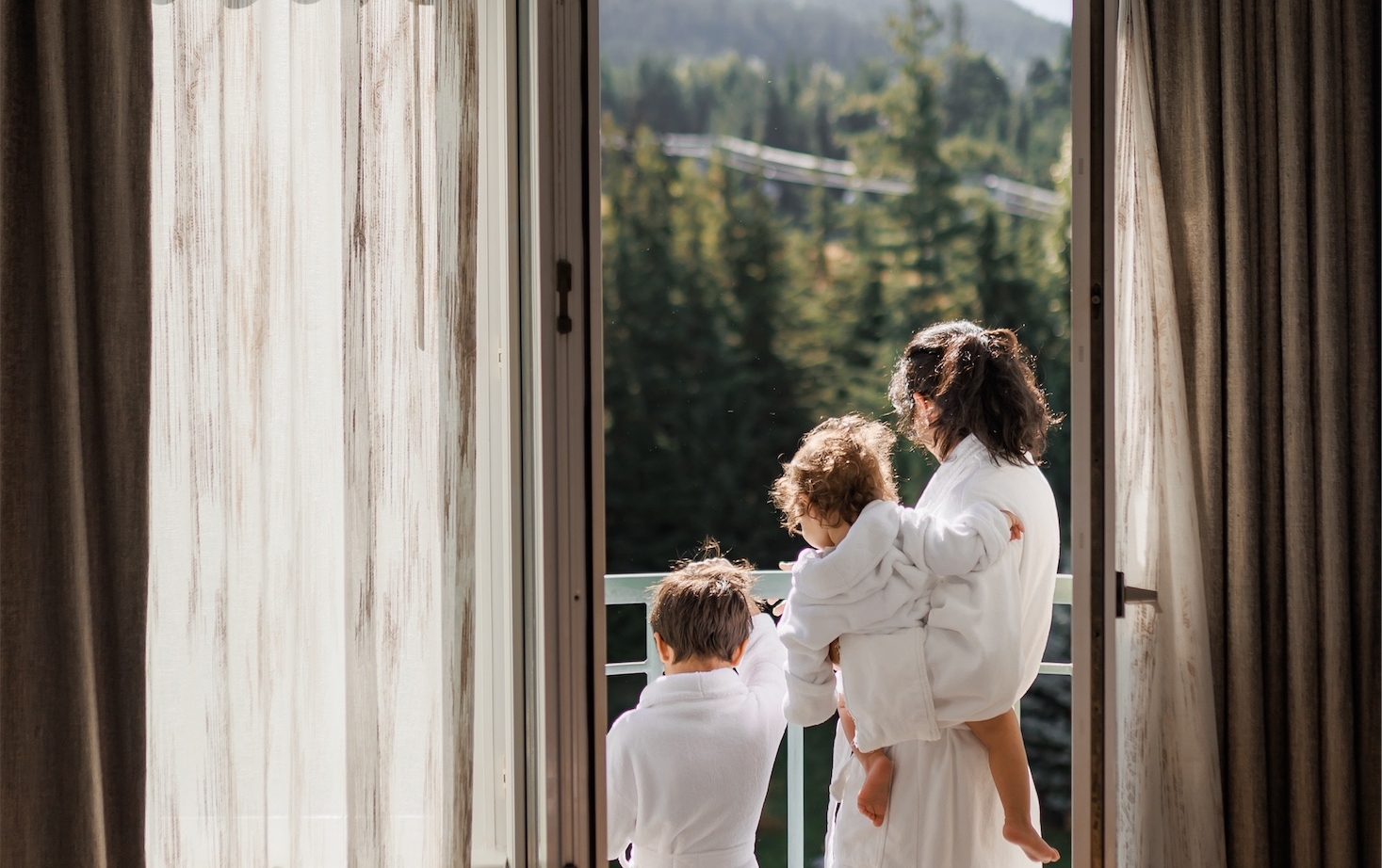 family looking out a the property from their balcony