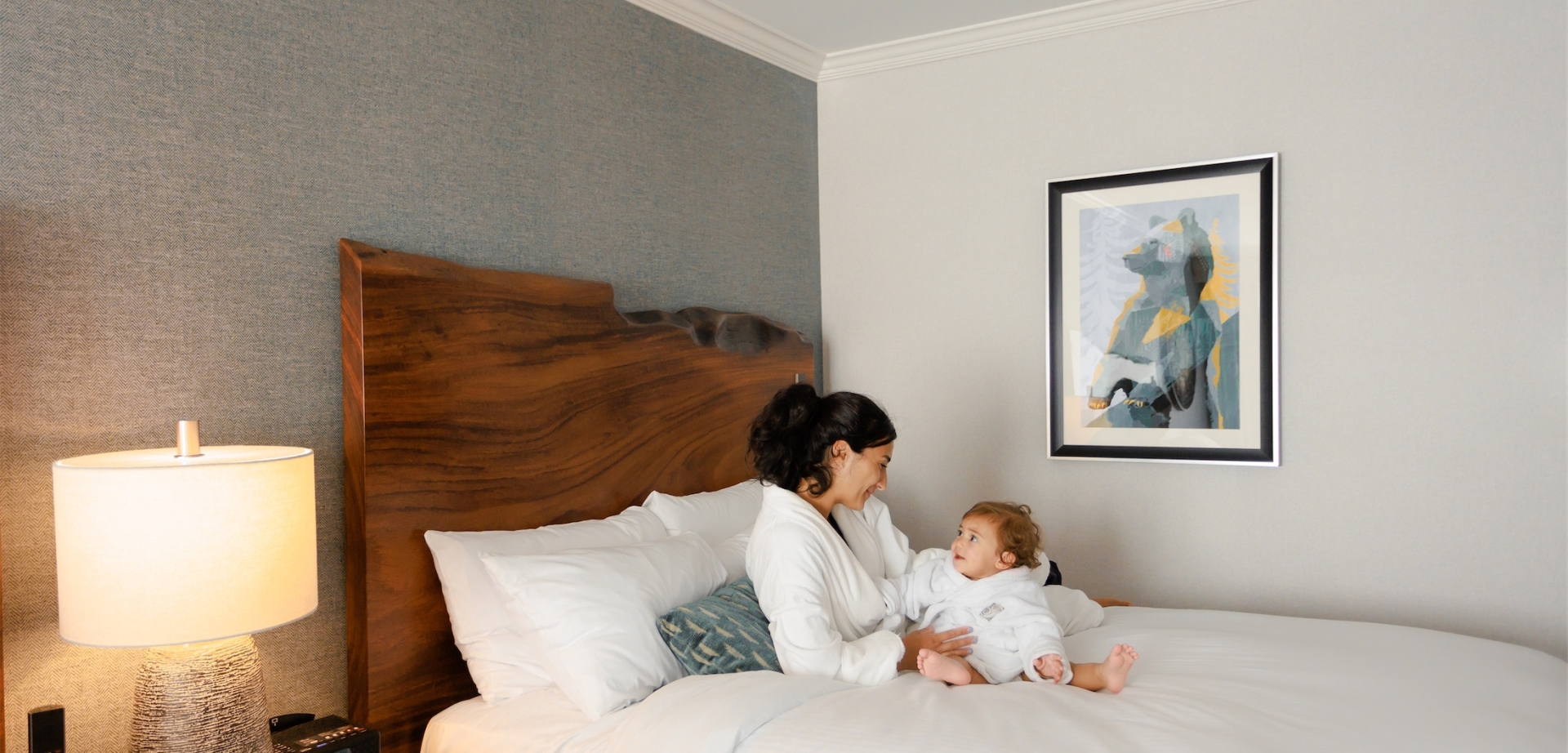 mother and baby in robes cuddling in bed