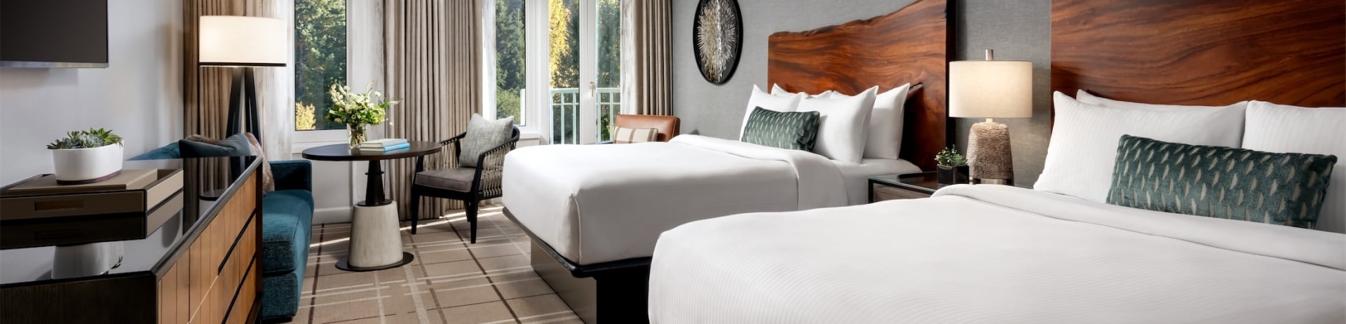 bedroom with two beds and a small table and sofa