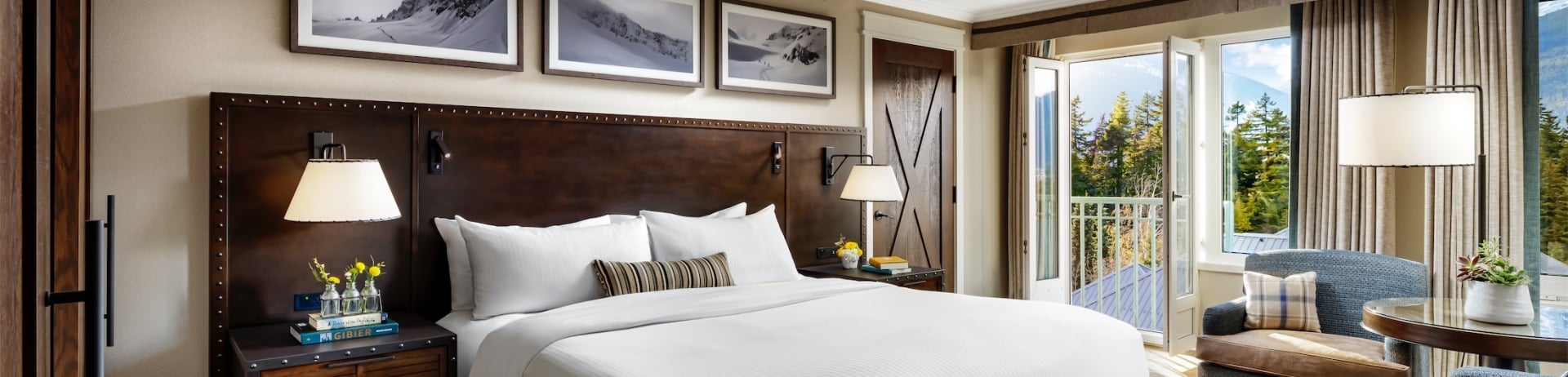 bedroom with small seating area and balcony