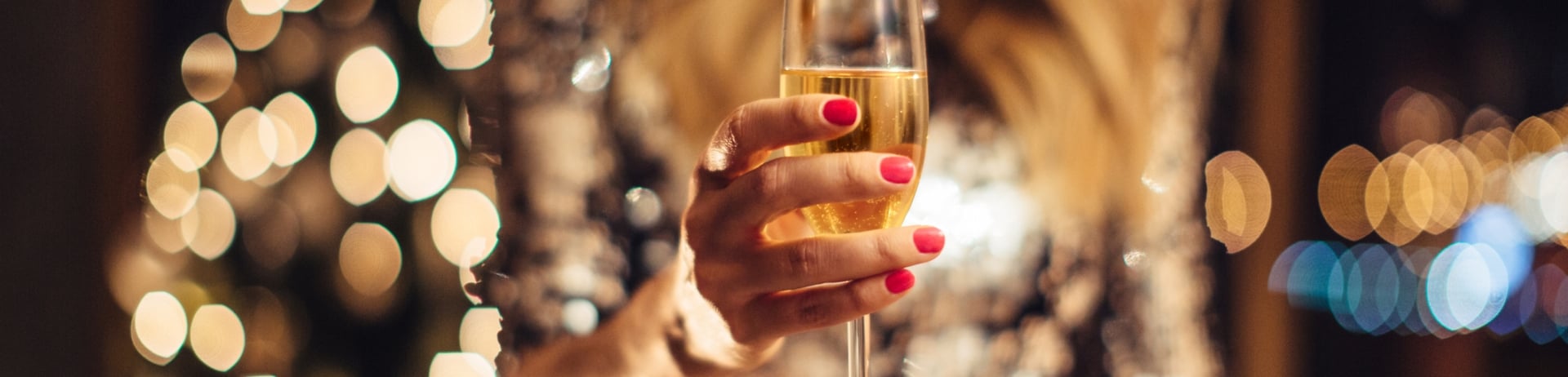 Close up of woman's heands holding glass of champagne