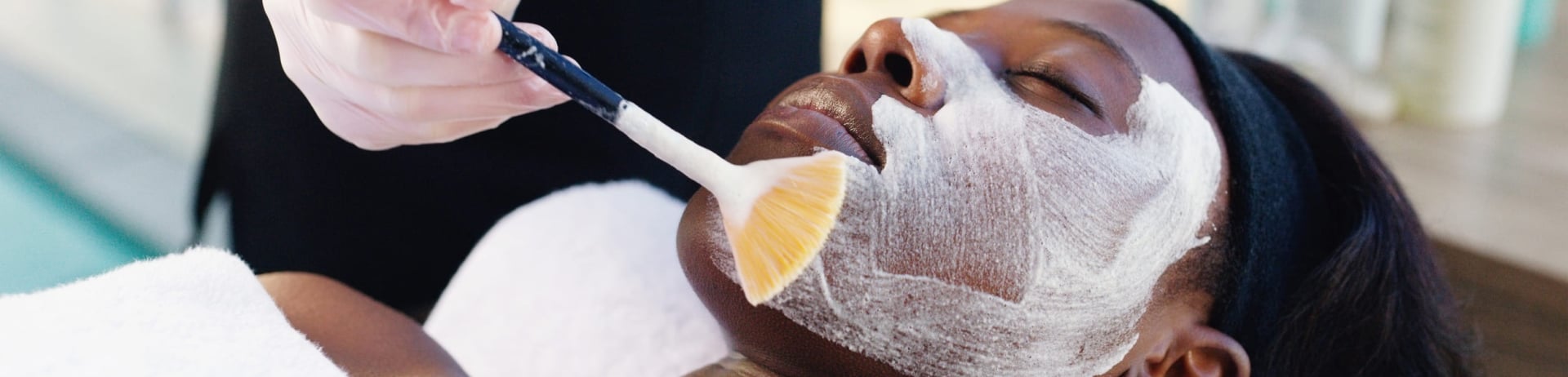 woman receiving a spa facial treatment