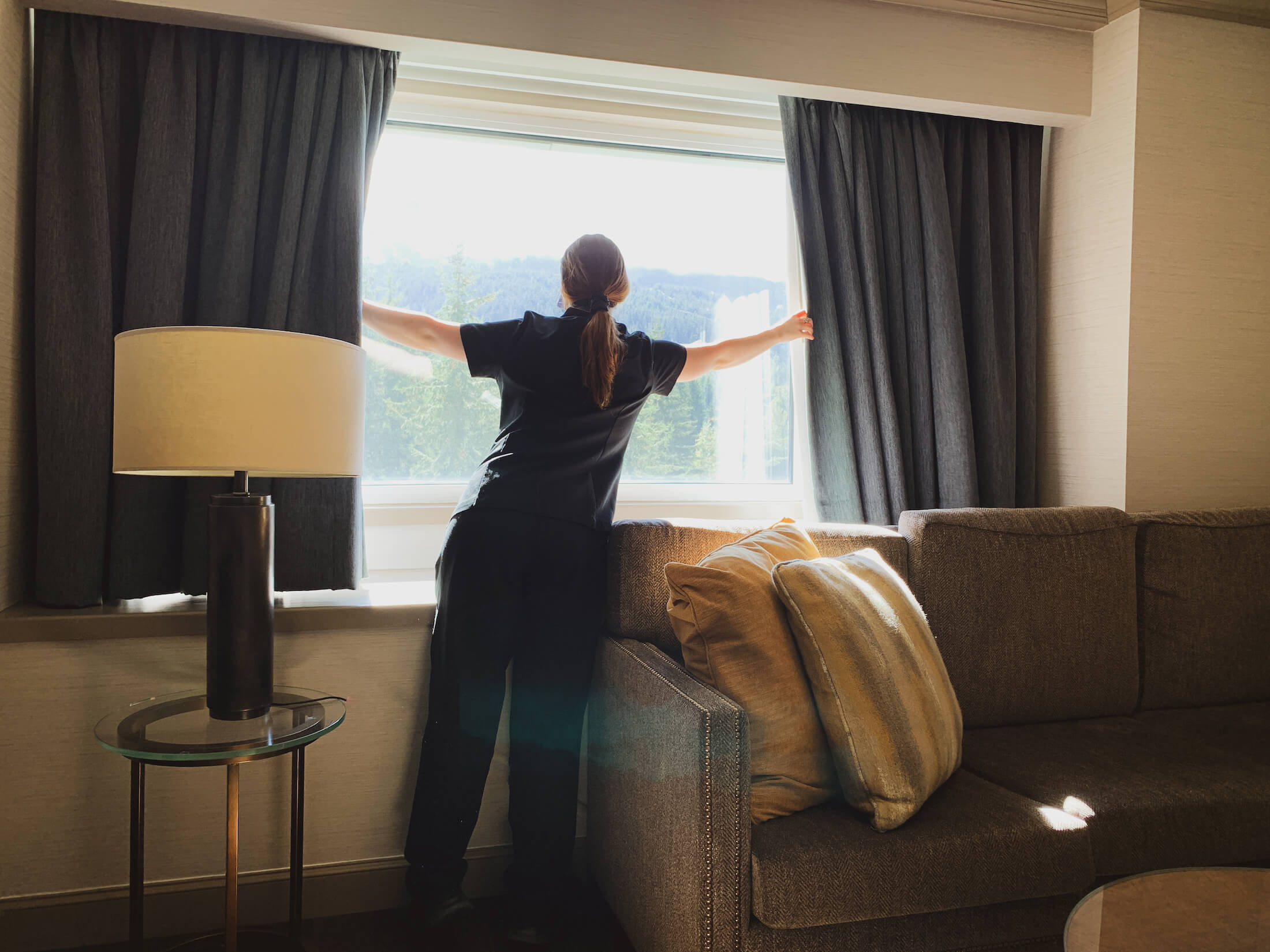 housekeeping opening blinds at Fairmont Chateau Whistler