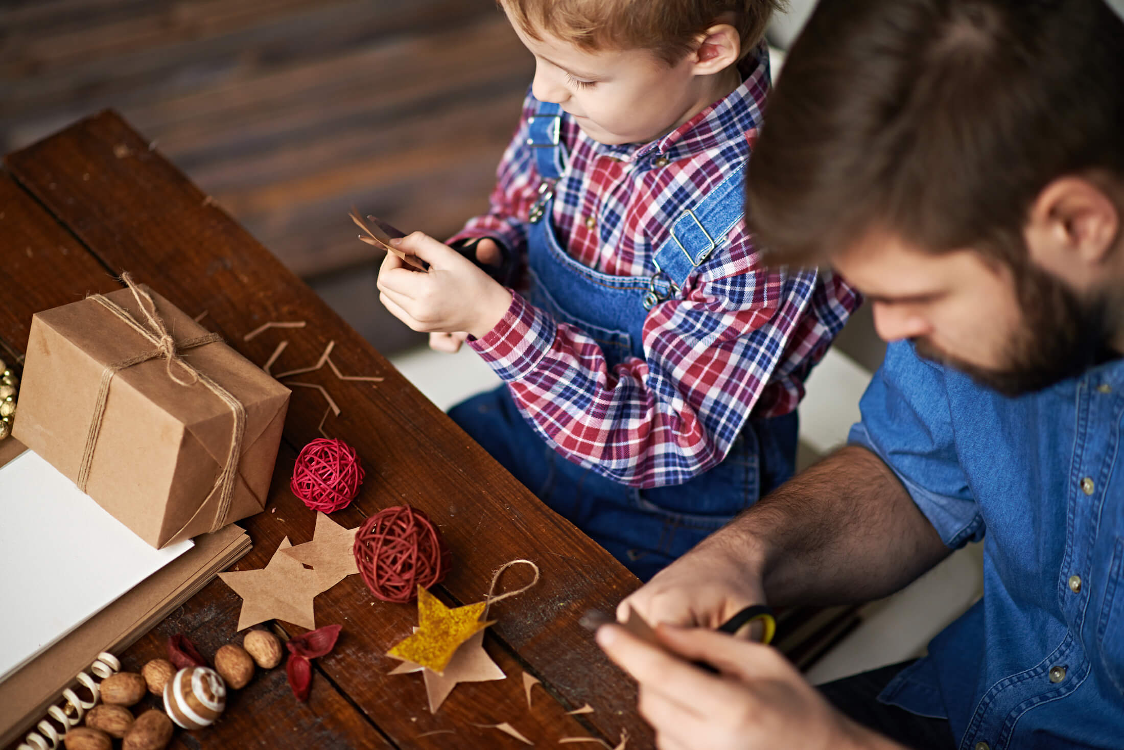 a man and a child work on individual crafts