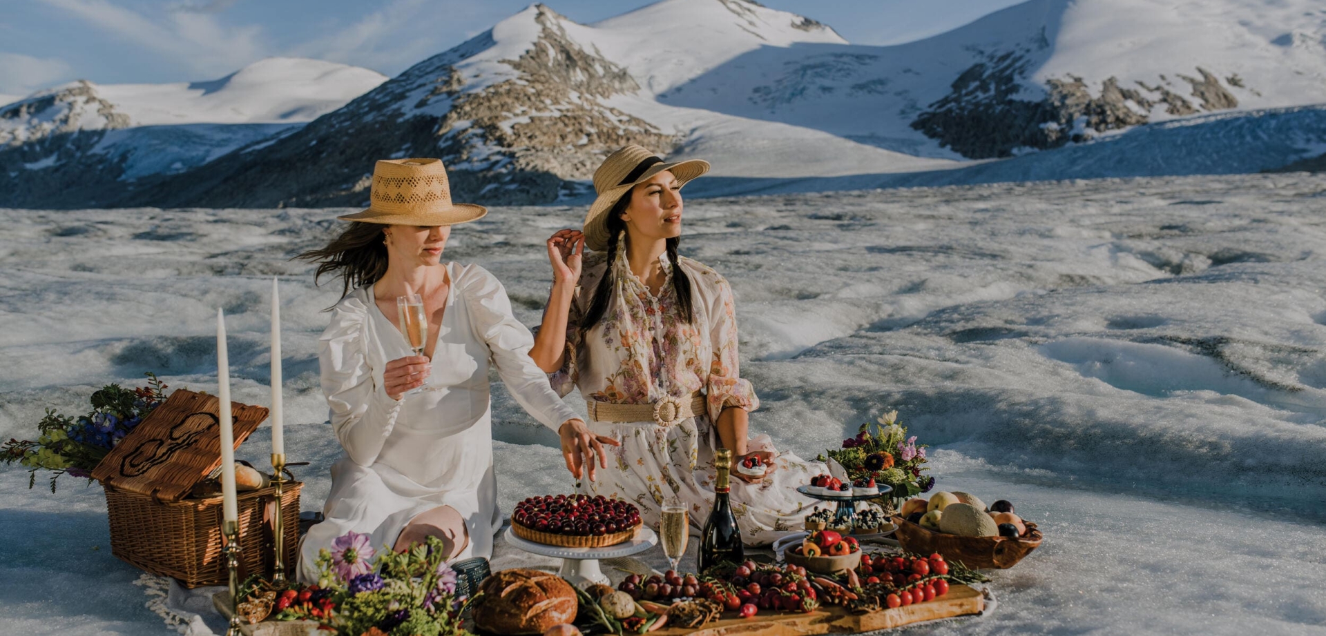 two women enjoying picnic on snow