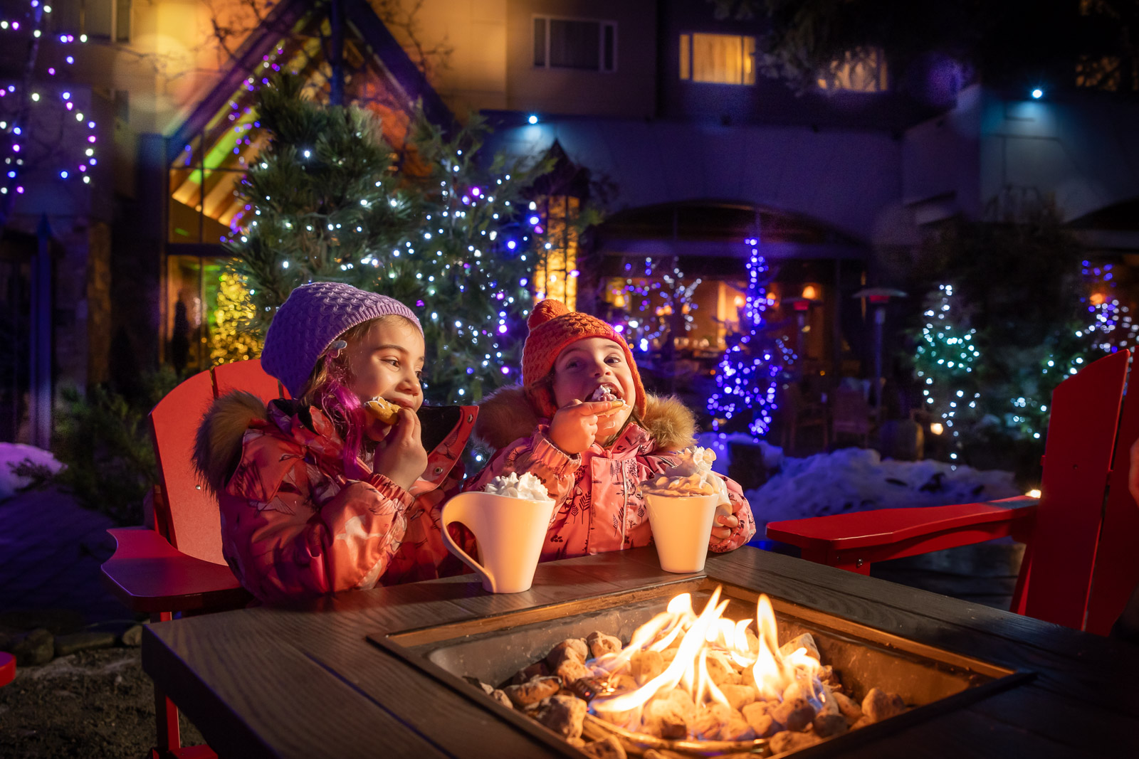 Hot chocolate by the fire two kids having a cookie and hot chocolate festive celebrations at fairmont chateau whistler