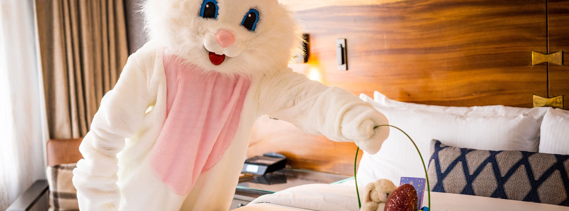 easter bunny leaving easter amenity on a fairmont bed