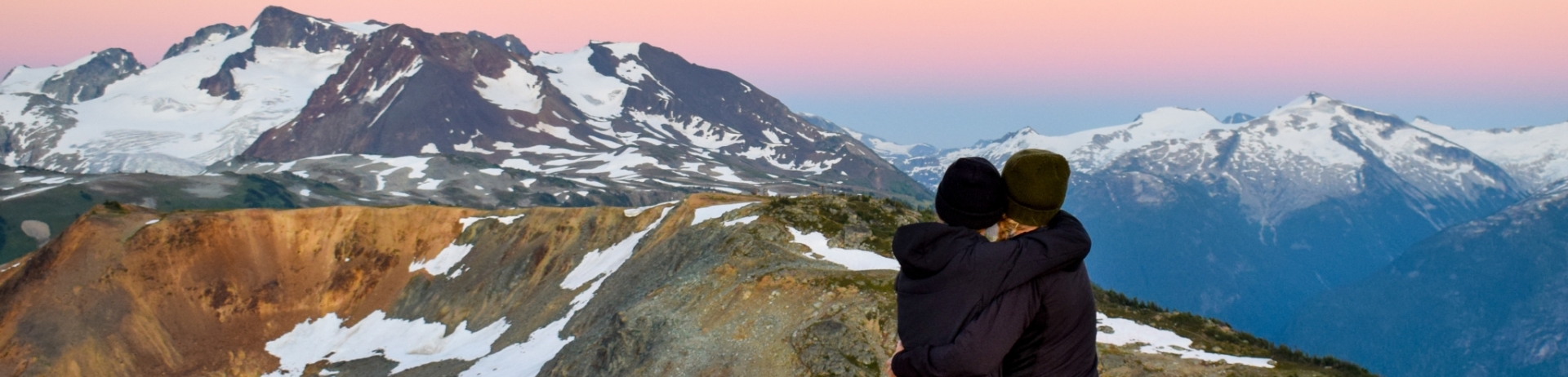 Friends hugging on a Whistler mountain top