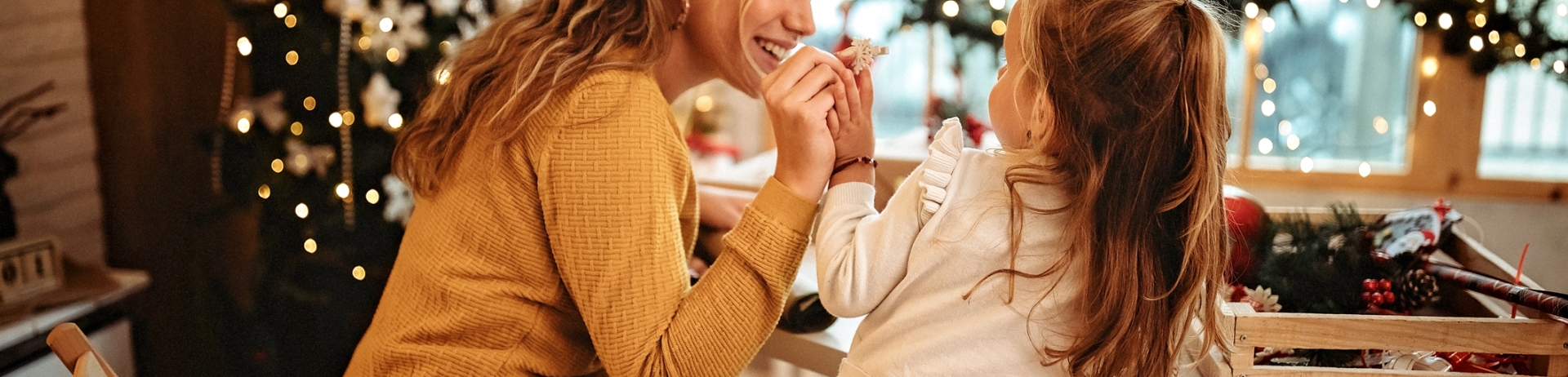 Mother and daughter making festive ornaments