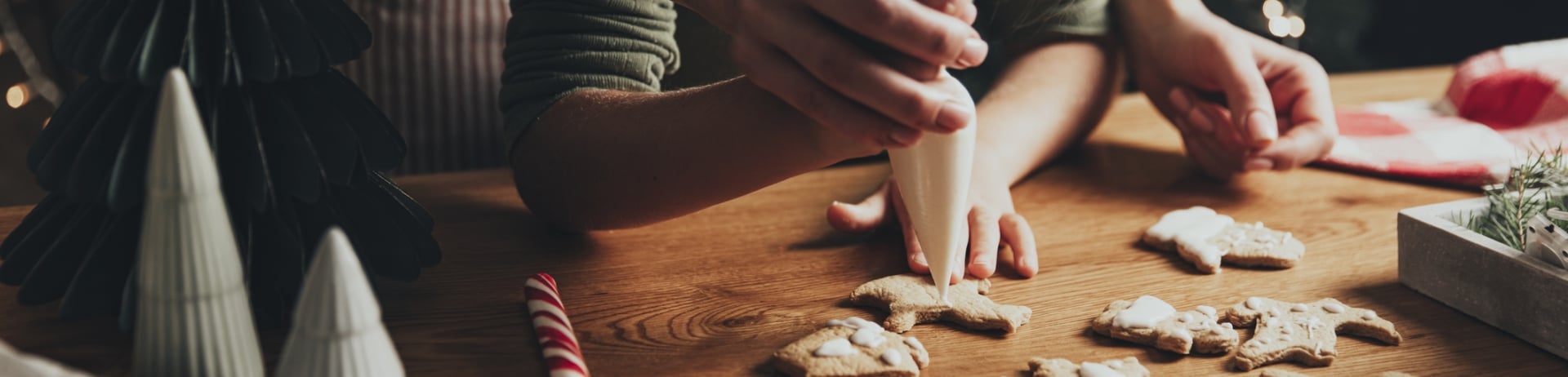 Parents decorating festive cookies with their child at the Fairmont Chateau Whistler