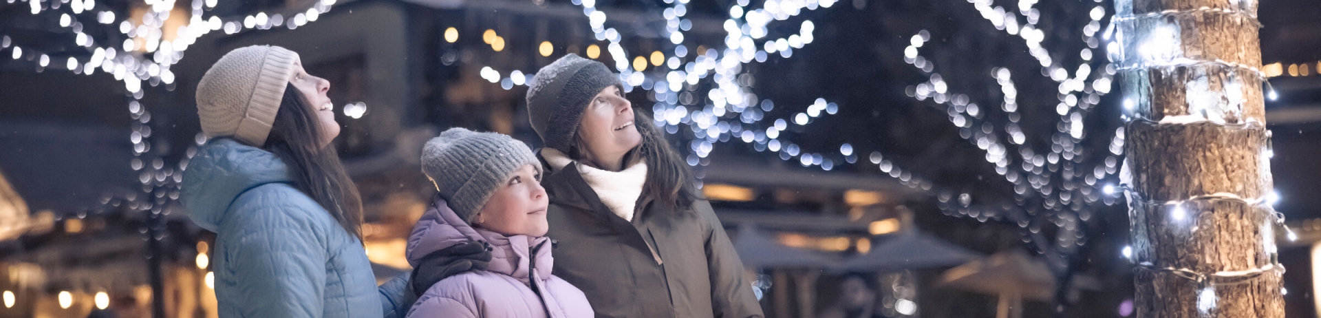 Family enjoying the Village Stroll in Whistler, British Columbia on a snowy winter evening