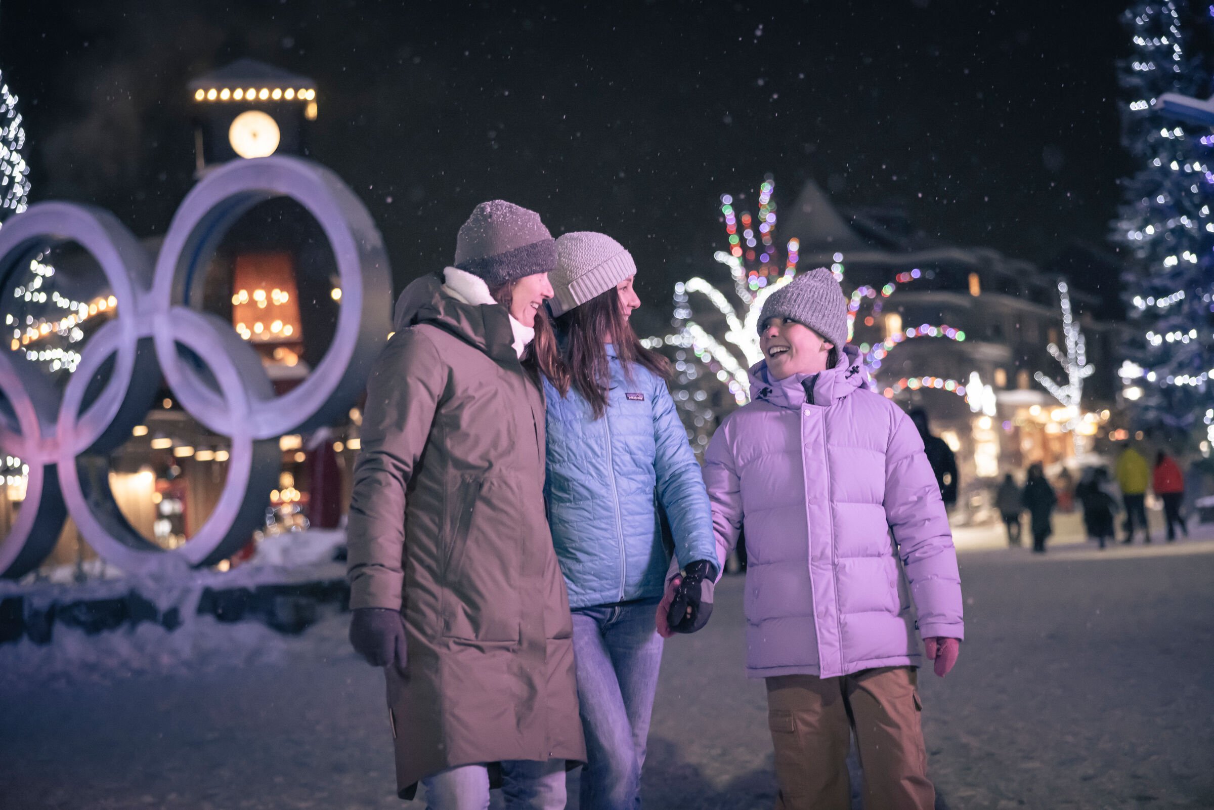 Family enjoying the Village Stroll in Whistler, British Columbia on a snowy winter eventing
