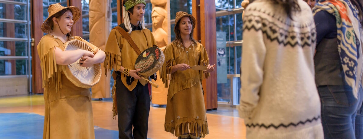Indigenous people educating visitors of the Squamish Lil Wat Cultural Centre.