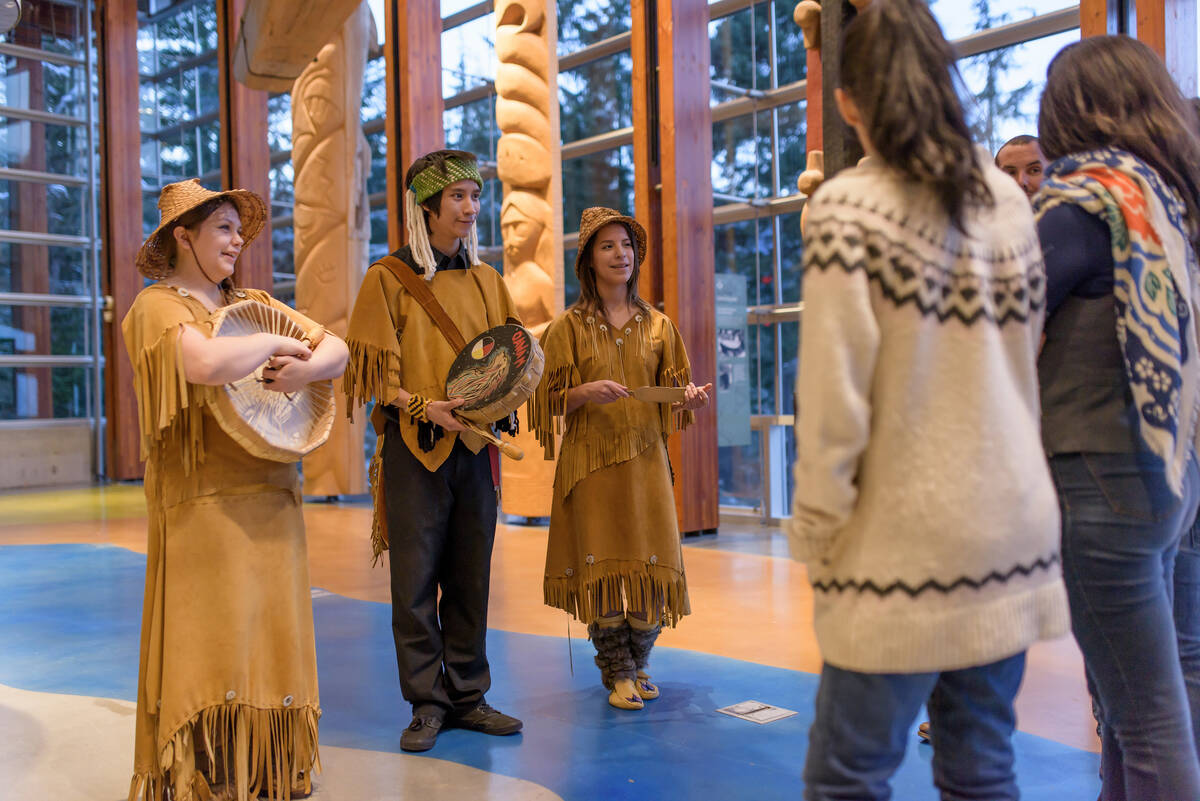 Indigenous people educating visitors of the Squamish Lil Wat Cultural Centre.