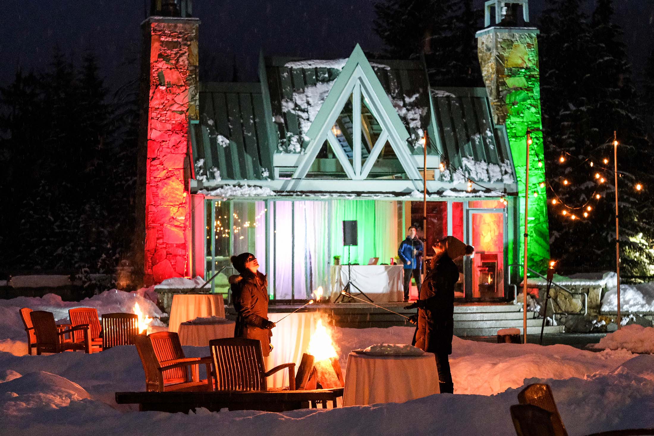 People roasting marshmallows by the fire.