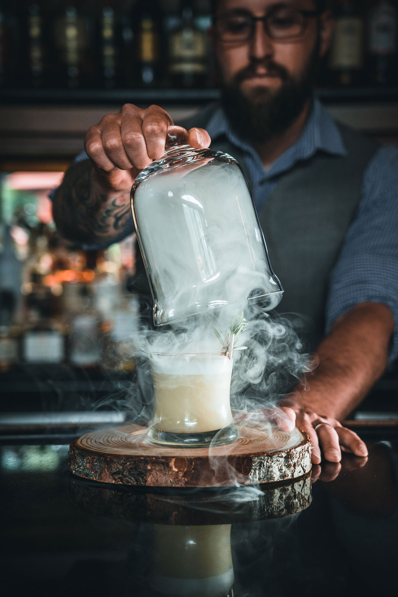 bartender revealing smokey cocktail