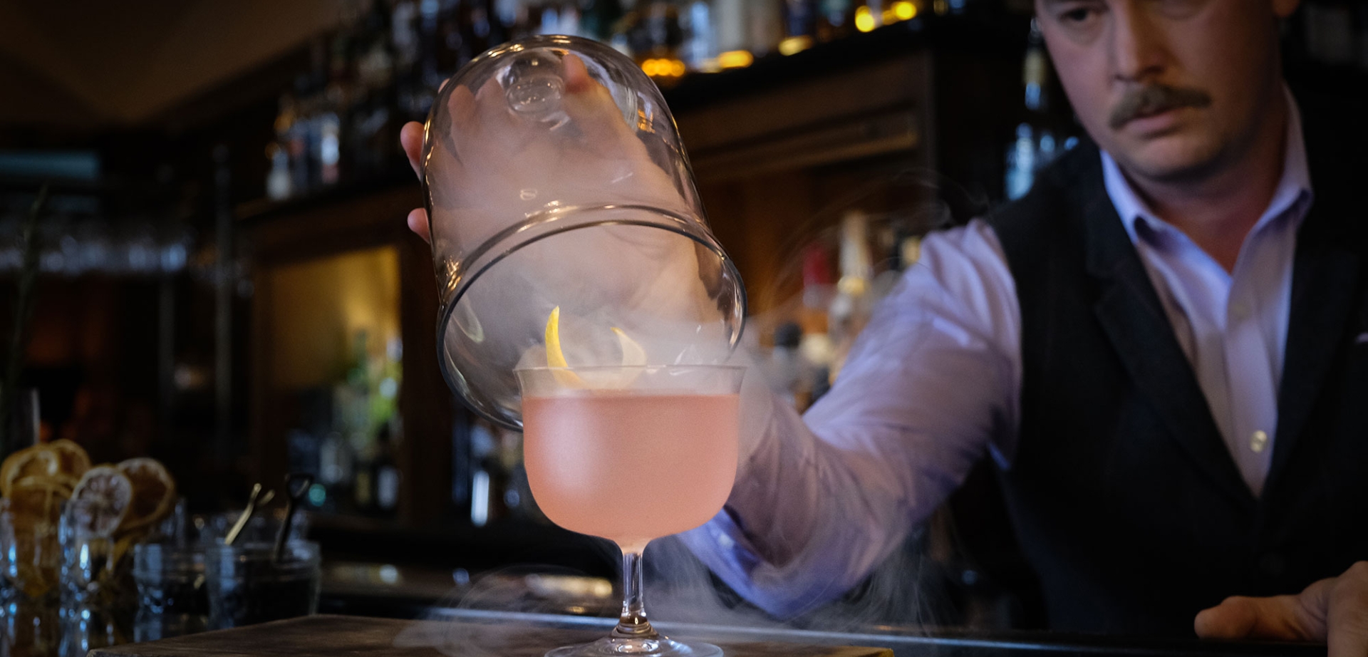 bartender revealing smokey cocktail at the mallard lounge