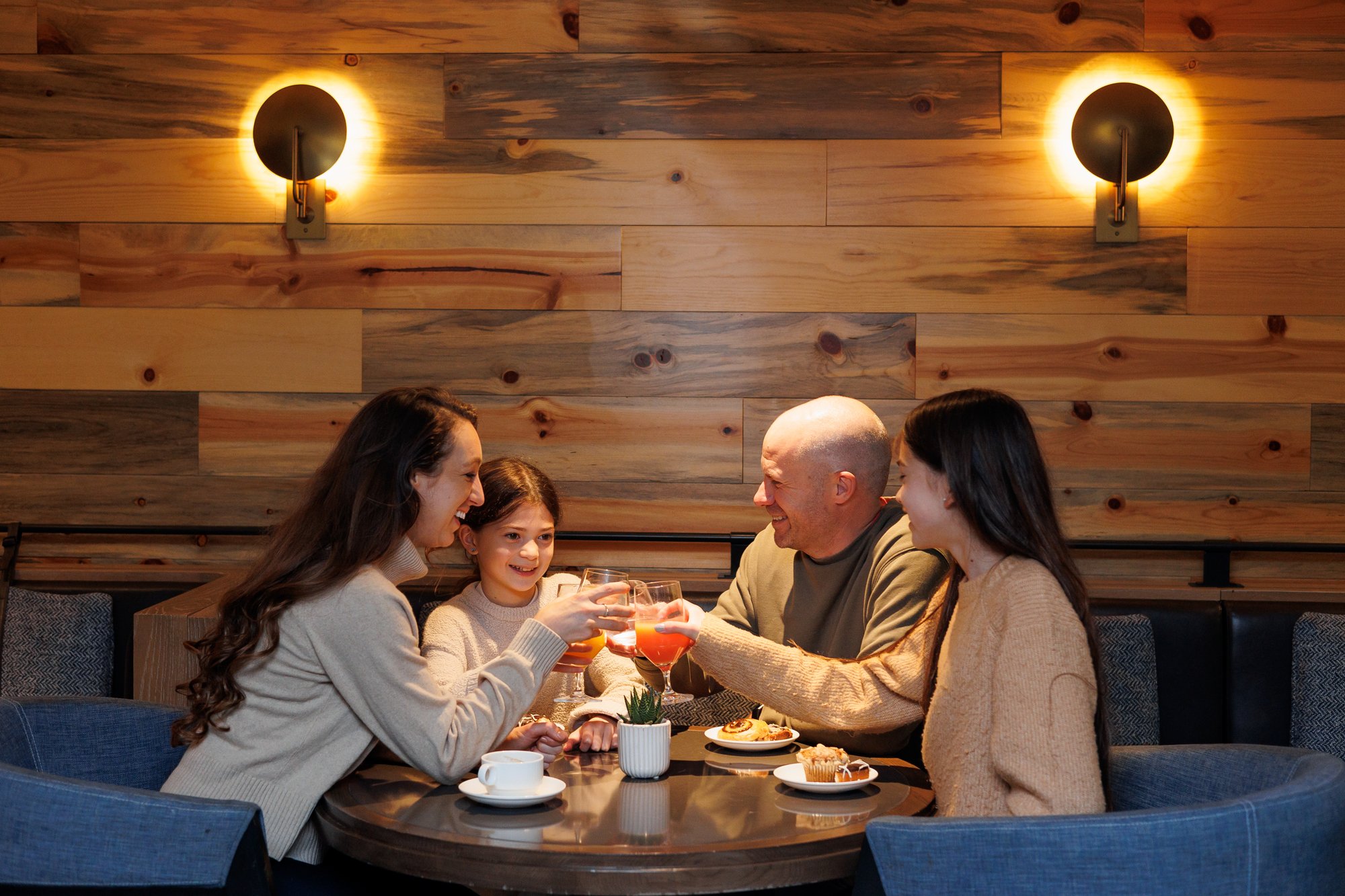 family at gold lounge dining together