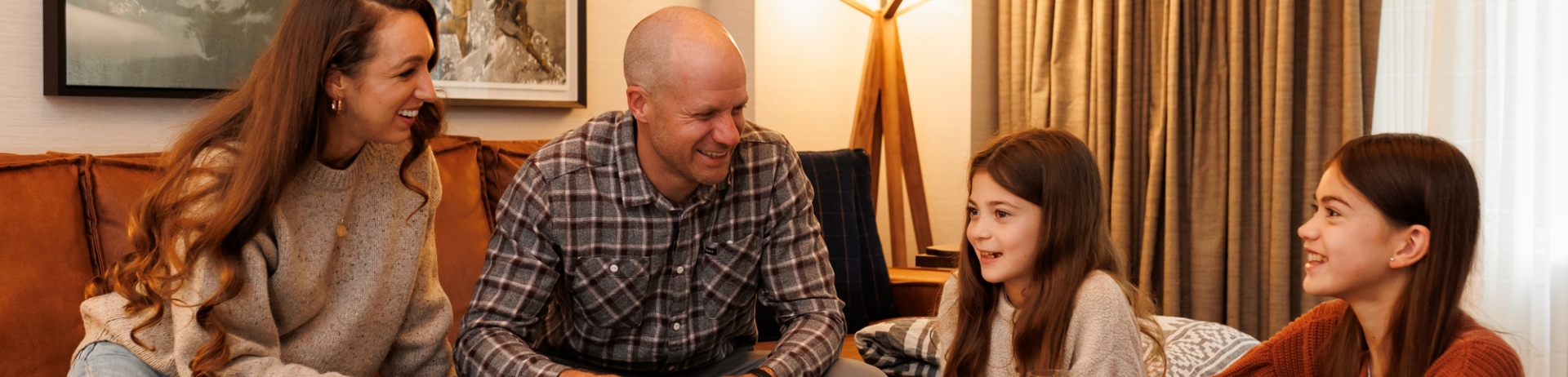 lifestyle image of a family playing cards in a guest room
