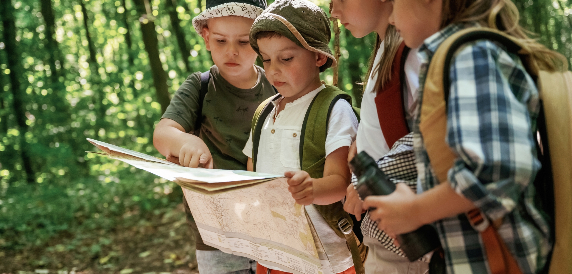 Kids reading a map at a summer event at Fairmont Chateau Whistler