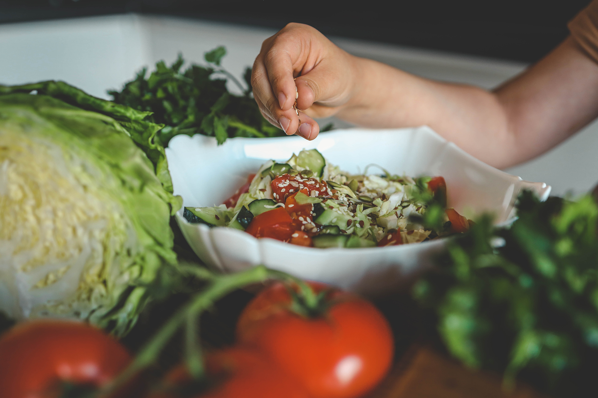 kid preparing salad bowl