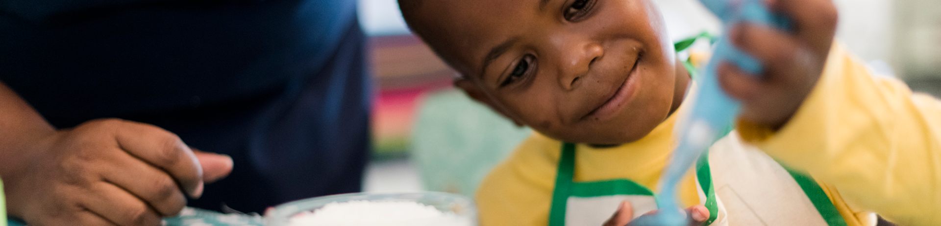 kid decorating cupcake