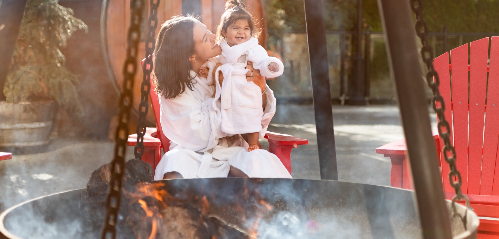 Mother and daughter enjoying relaxing bonding time fireside at the health club at Fairmont Chateau Whistler
