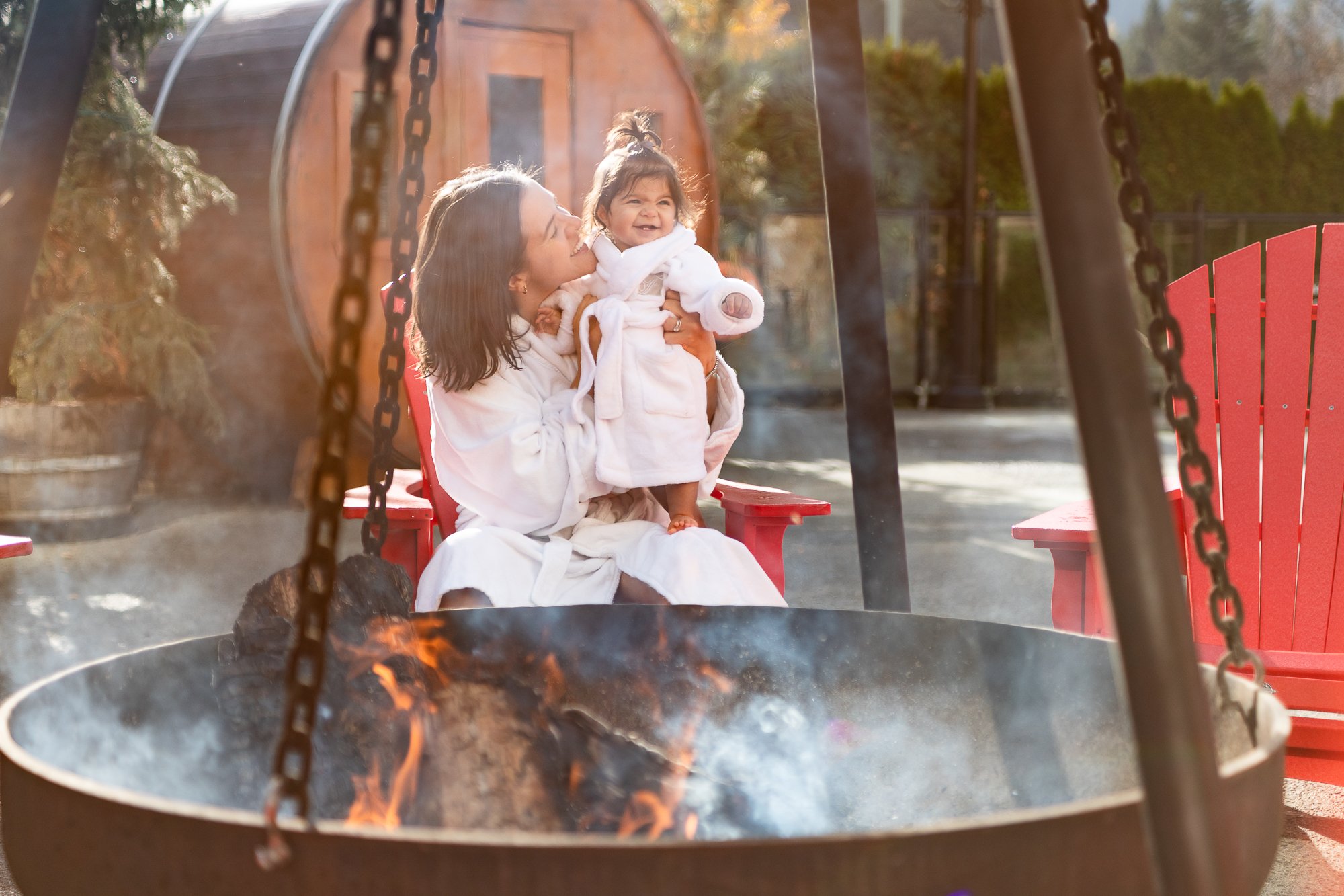 Mother and daughter enjoying relaxing bonding time fireside at the health club at Fairmont Chateau Whistler