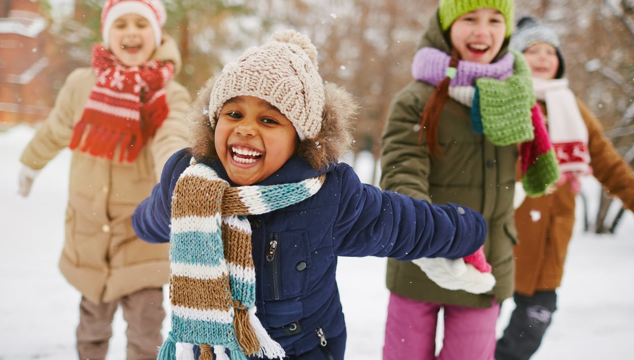 Cheerful girl and her friends spending time outdoors