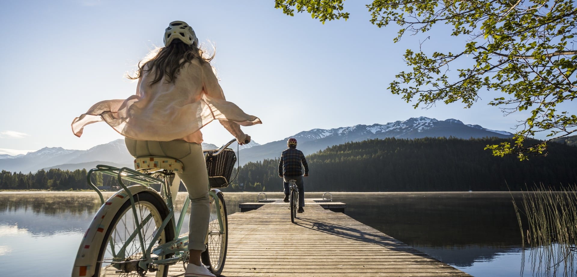 two people biking on a dock at rainbow park in whistler