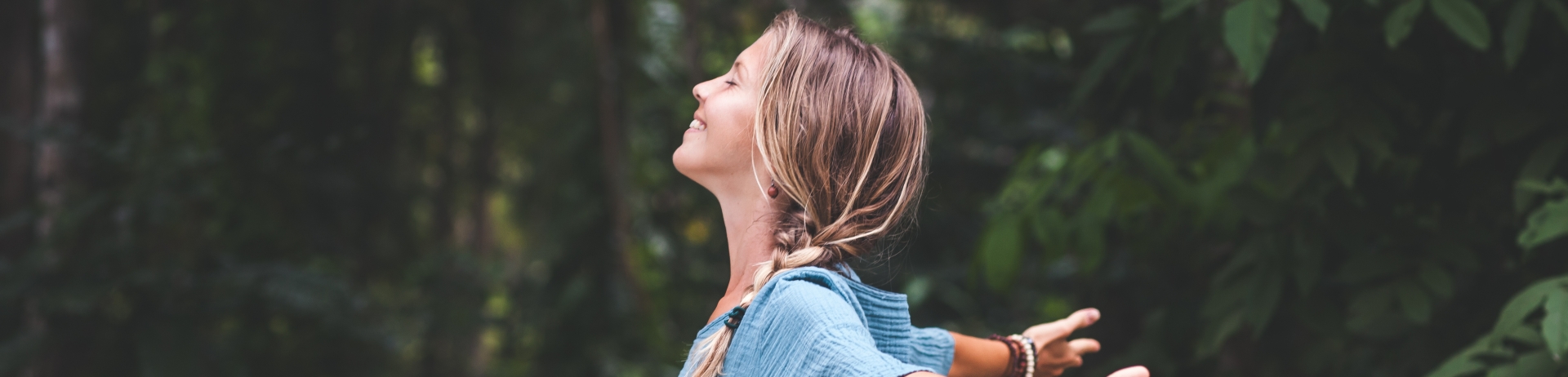 Women in forest connecting with nature