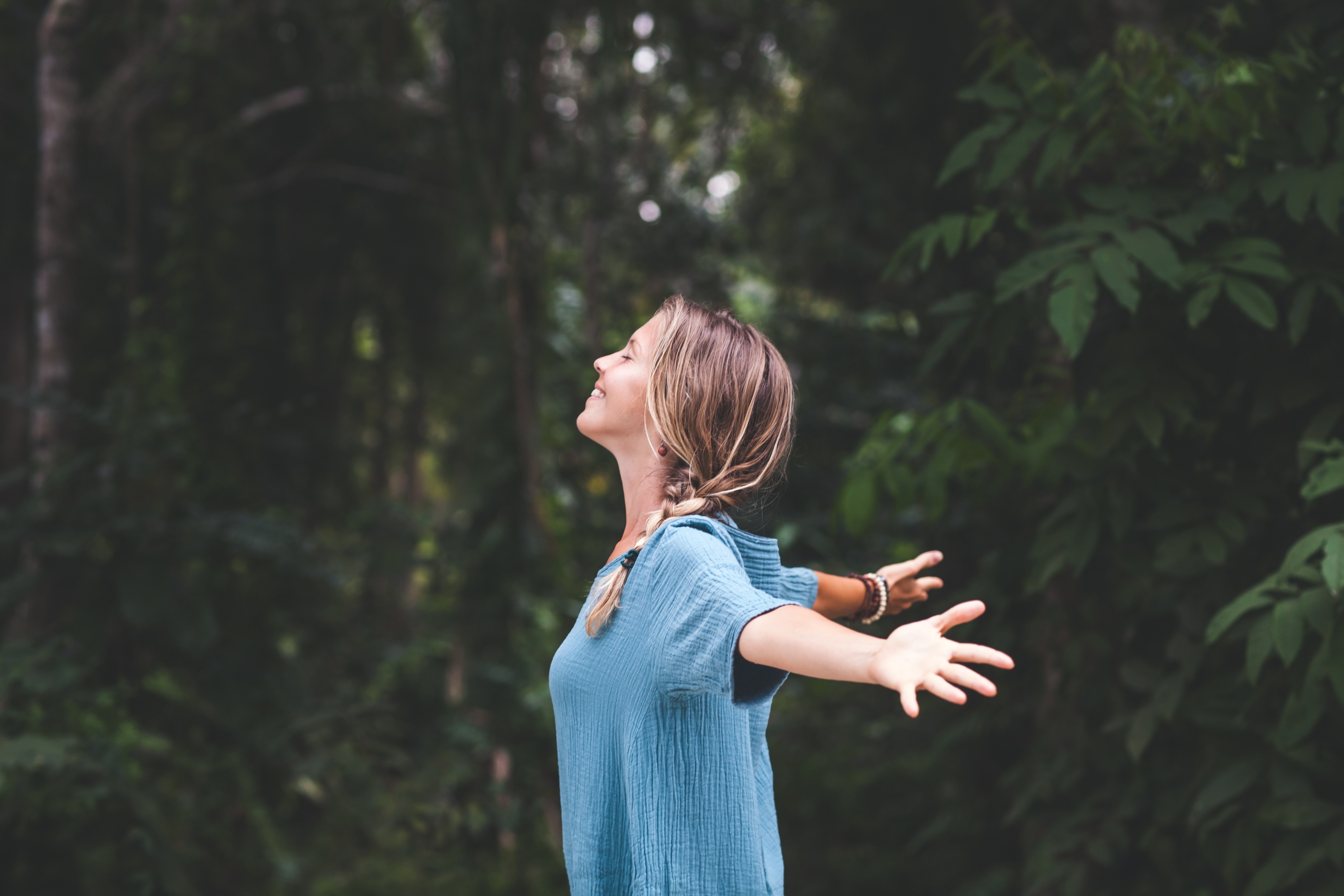 Women in forest connecting with nature