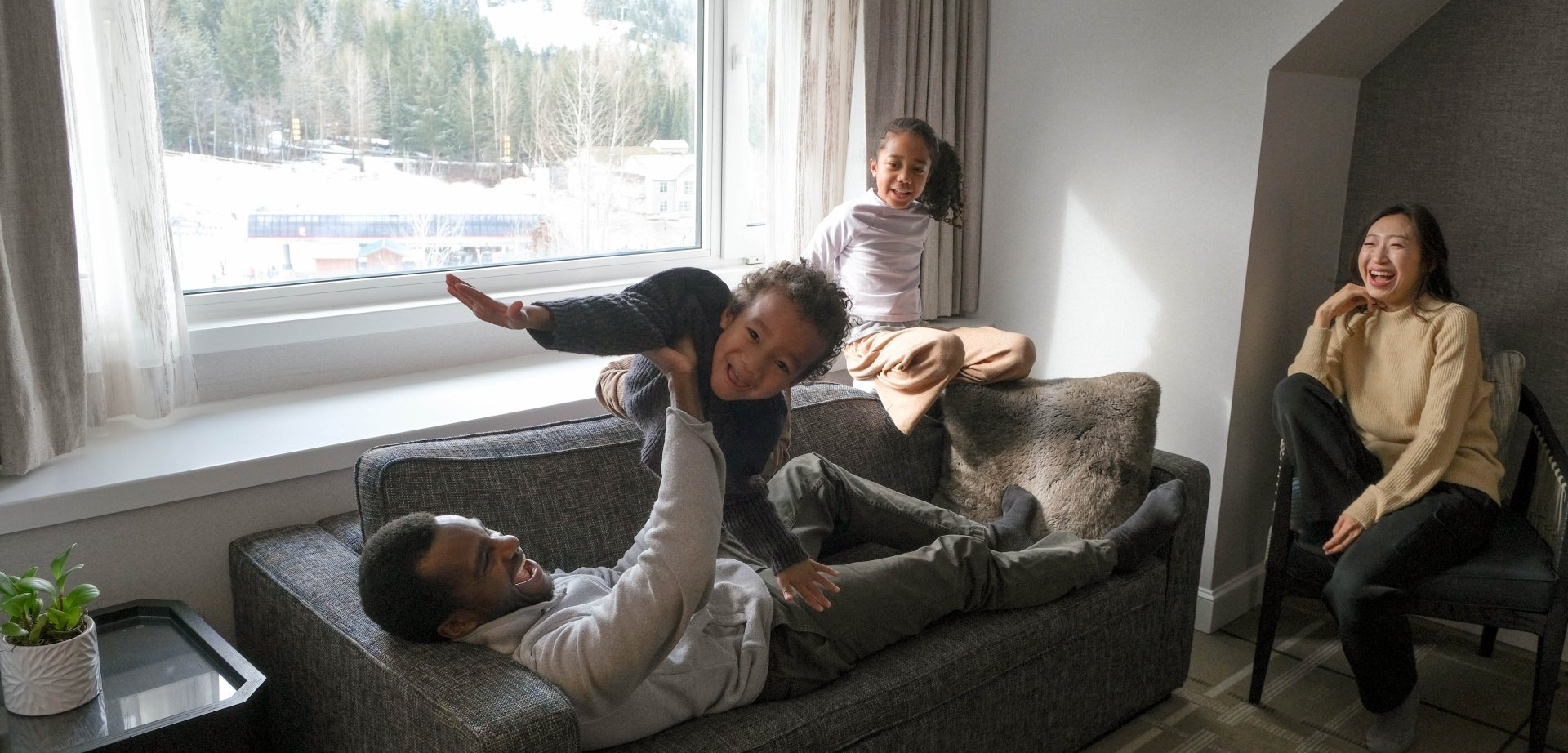 family sharing quality time in room at fairmont chateau whistler winter